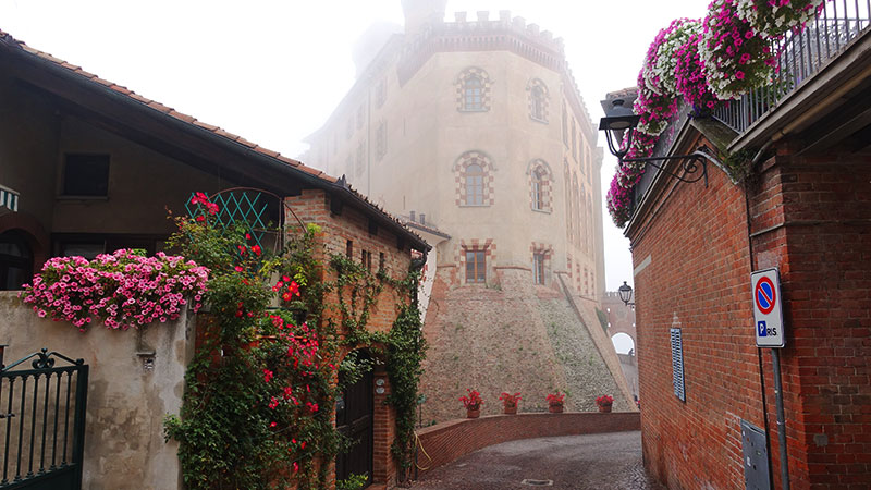 Bilde fra hovedgaten i landsbyen i Barolo med hus pakket inn i tke